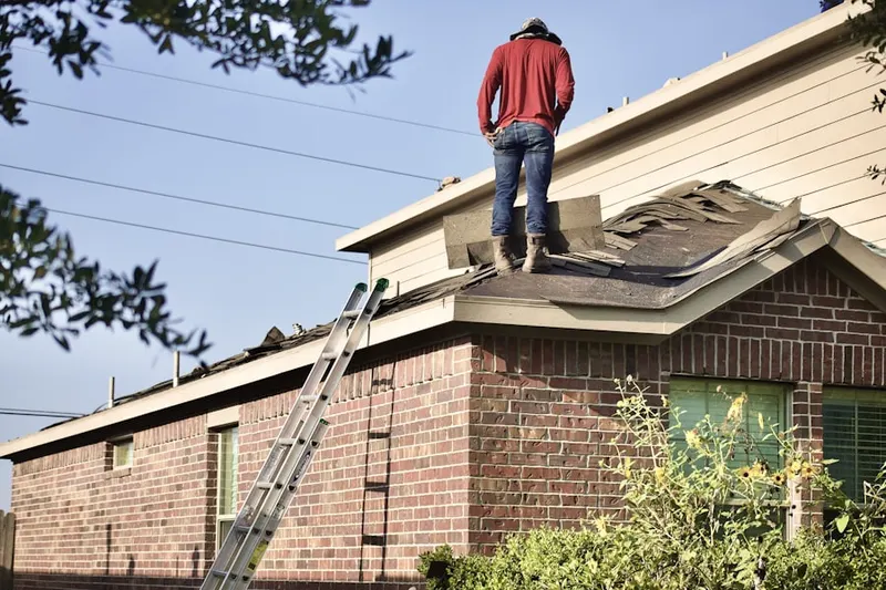 Professional roofer working on a residential roof in Tuscarora